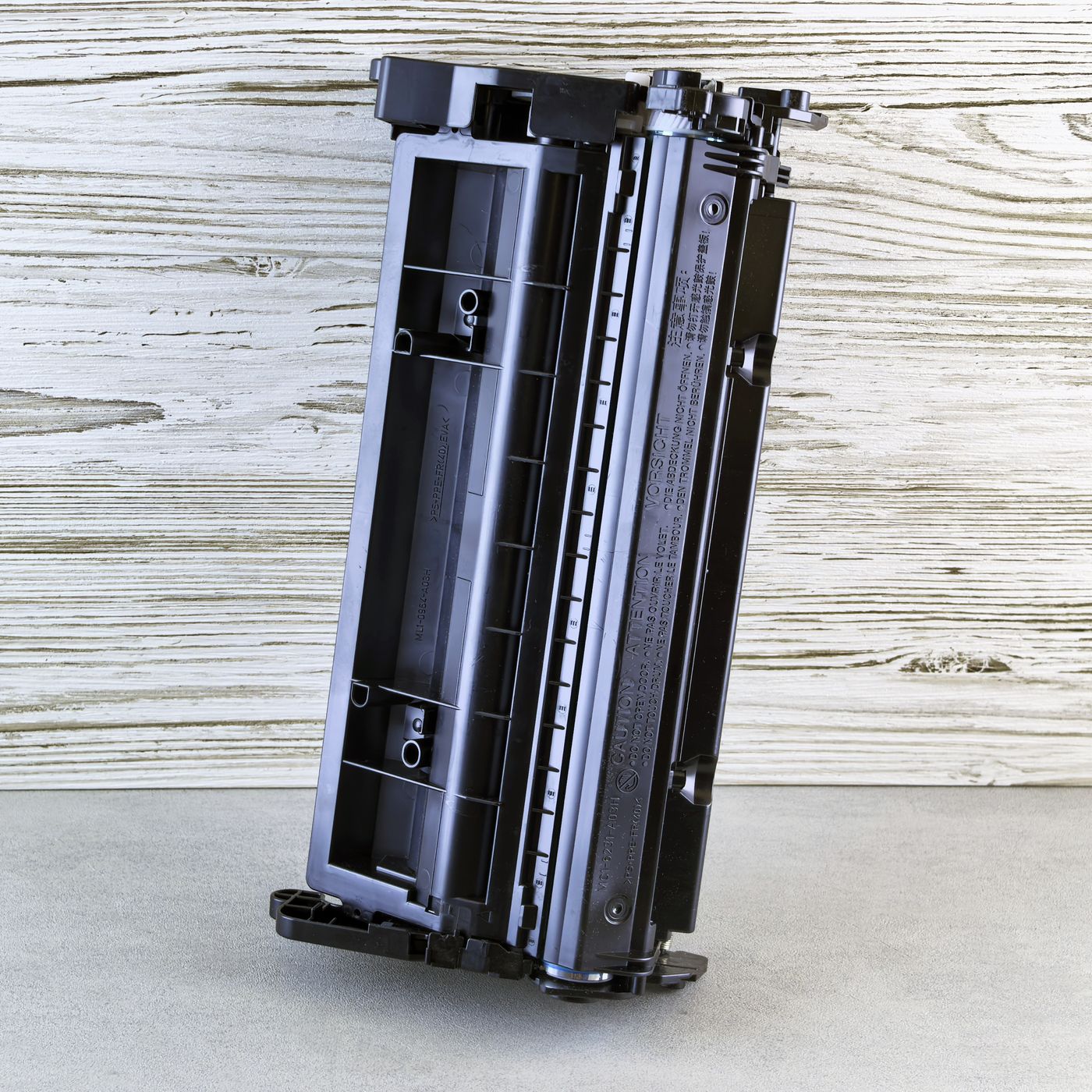 A black laser toner cartridge on a desk