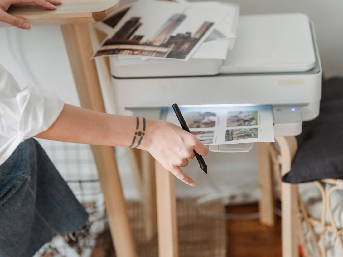 Someone operating a printer at a home desk
