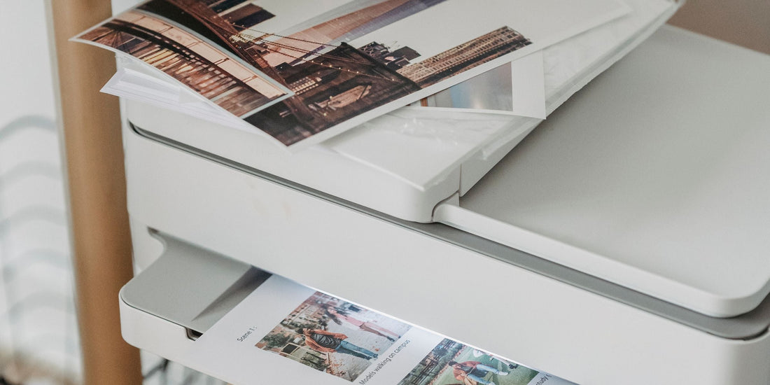 A home office desk with a printer and printed pages